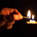 Una persona esta sin luz en su casa, se ve su mano tratando de prender una vela en este corte de luz en Cundinamarca.