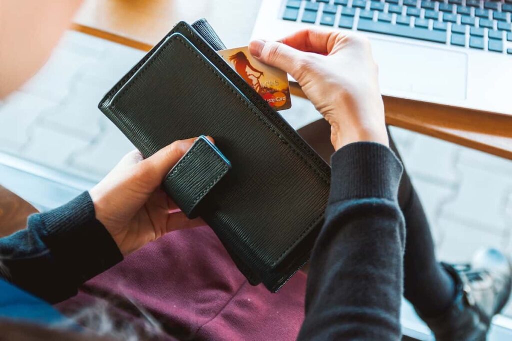 una mujer con su cartera y su tarjeta de crédito dinero a tu negocio.