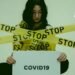 Una mujer rodeada de cintas que dicen stop del covid-19