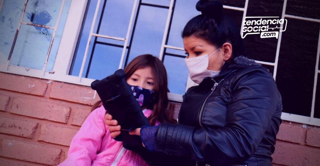 Una niña y una señora están viendo su tableta educativa